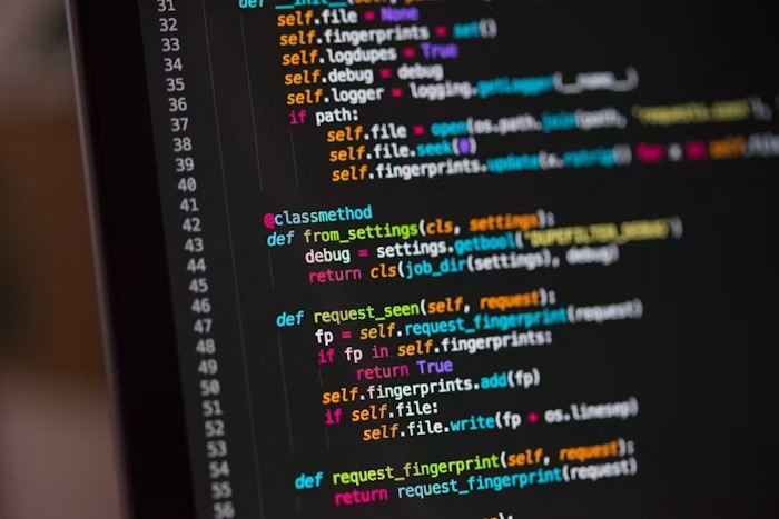 Developer writing code on a laptop